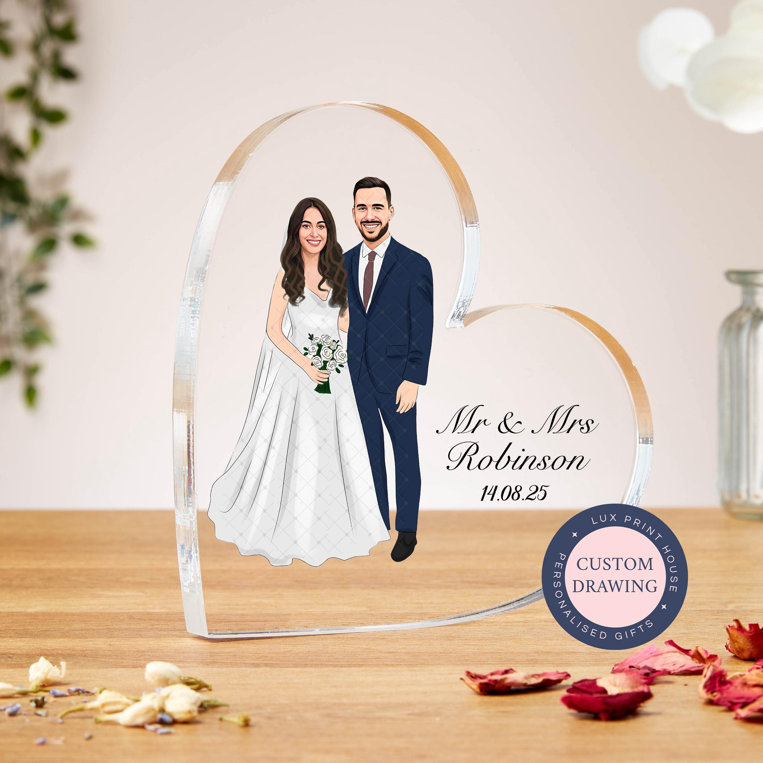 Personalised acrylic heart-shaped block featuring a custom faceless portrait drawing from the couple’s own wedding photo. Includes custom names and wedding date for a meaningful keepsake. Perfect as a unique wedding gift, anniversary present, or bridal shower surprise, this custom illustration captures the love and joy of the couple’s special day in a beautiful, lasting display.