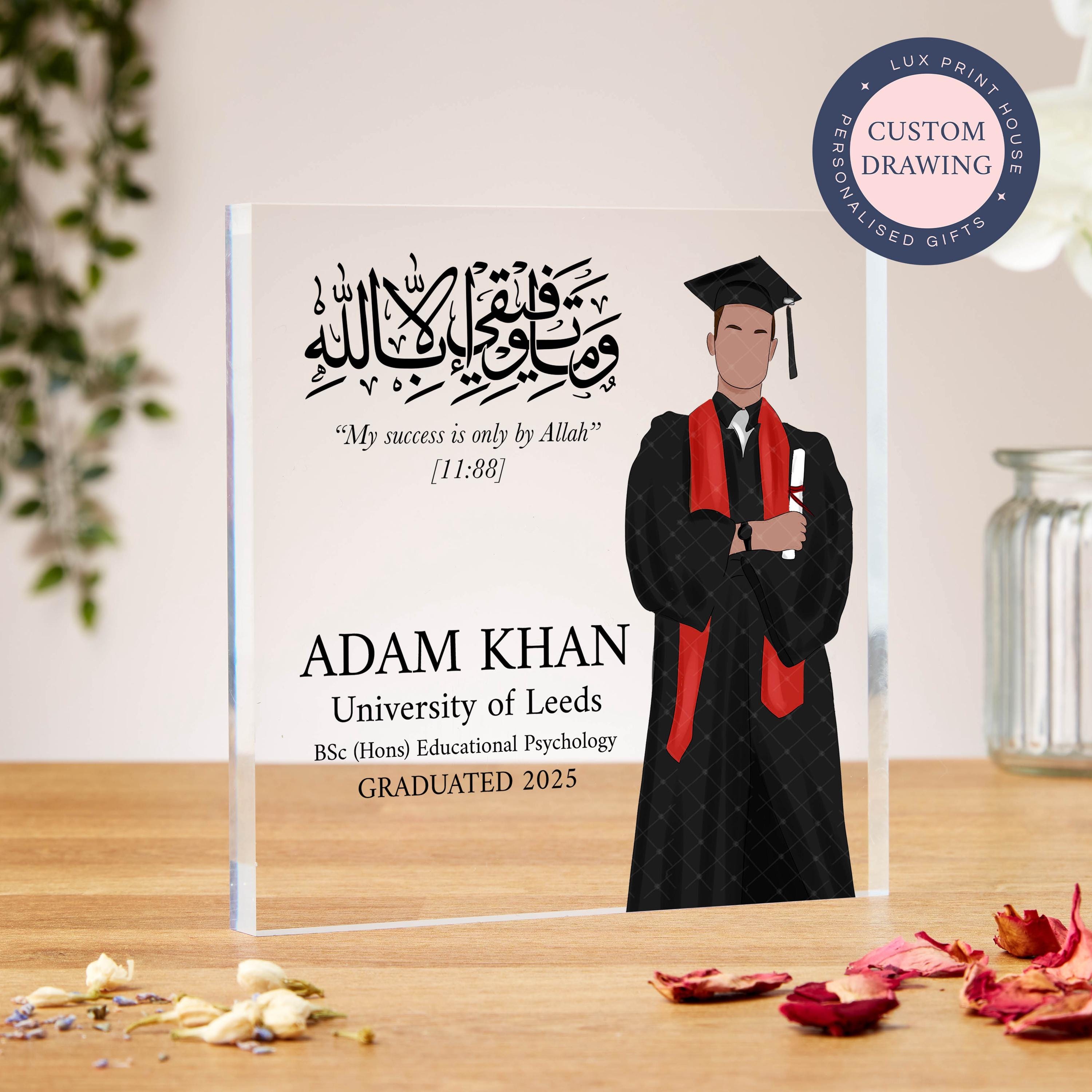 A custom Islamic graduation acrylic block featuring a faceless portrait of a male graduate in a gown and mortarboard with a red stole, holding a diploma. Arabic calligraphy above displays the verse: “My success is only by Allah” [11:88]. Designed for Muslim graduates, this personalised keepsake allows customisation of name, degree, university, and year—ideal for a son, brother, nephew, or friend. A meaningful and modern faith-inspired gift.